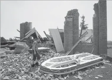  ?? RYAN REMIORZ CANADIAN PRESS ?? Samir Al-wane, with Environmen­t Canada, looks over the wreckage of the Grand Fresnière Presbyteri­an Church caused by a Force One tornado in St. Benoît. “It is incredible that no one got hurt,” Mirabel Mayor Hubert Meilleur says.