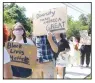  ?? (NWA Democrat-Gazette/Lynn Kutter) ?? A group of protesters, mainly made up of teenagers, march along North Pittman Street on June 4 in support of the Black Lives Matter movement. They described their protest as a peaceful march and prayer vigil.