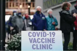  ??  ?? People wait in line to receive the first of two doses of the Pfizer vaccine at the one-day clinic at the Amazon.com facility in Seattle on Sunday.