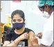  ?? PTI ?? A woman receives a Covid-19 vaccine dose in Mumbai.