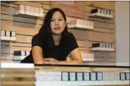  ?? DAVID ZALUBOWSKI ?? In this Friday, July 26, 2019 photo, Leslie Siu poses for a portrait next to her cannabis products geared toward women on display in Groundswel­l dispensary in east Denver.