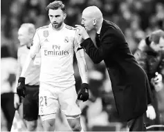  ??  ?? Real Madrid coach Zinedine Zidane talks to Borja Mayoral during the UEFA Champions League Group H match against Borussia Dortmund at the Santiago Bernabeu stadium in Madrid. — AFP photo