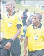  ?? (Pic: Sanele Jele) ?? FIFA Accredited Referee Thulani Sibandze (L) and assistant Referee Petros Mbingo walk off the pitch after officiatin­g in the MTN Premier League game between Mbabane Swallows and Green Mamba at Somhlolo National Stadium on Sunday.
