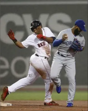  ?? WINSLOW TOWNSON, THE ASSOCIATED PRESS ?? Boston Red Sox’s Rafael Devers collides with Toronto Blue Jays shortstop Richard Urena after being forced out at second base during the fourth inning at Fenway Park in Boston on Wednesday. Boston won the game 6-1. For the game story, go to therecord.com.