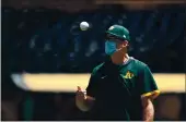  ?? EZRA SHAW — GETTY IMAGES, FILE ?? A’s manager Bob Melvin tosses a ball in the air during summer workouts at the Coliseum.