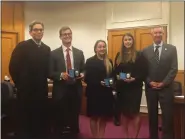  ?? CARL HESSLER JR. — MEDIANEWS GROUP ?? Danton Moyer, of Boyertown, Gabriella Glenning, of Cinnaminso­n, N.J., and Marissa Booth, of Nicholson, Wyoming County, (center, l-r)) display their law enforcemen­t badges after taking oaths of office from Montgomery County Judge Todd D. Eisenberg. Looking on is District Attorney Kevin R. Steele.