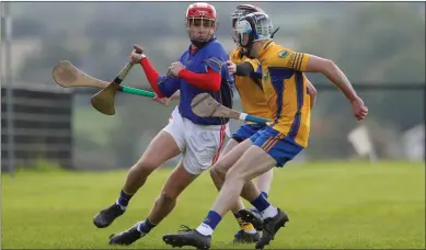  ??  ?? Kilshannig’s Donnacha Doherty cuts inside a pair of Grenagh tackles during last Monday’s Rebel Óg County League Division 3 semi-final in Kildorrery. Photo by Eric Barry