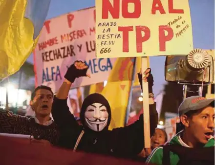  ?? EPA pic ?? Activists protesting against the Trans-Pacific Partnershi­p agreement in Lima, Peru, last Friday. An expert
says the next United States president will not implement immediate changes to the TPP.