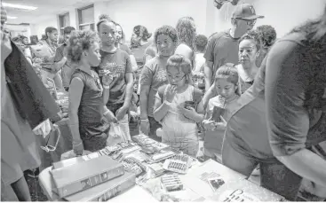  ?? Michael Ciaglo / Houston Chronicle ?? Students and parents pass tables with giveaways and informatio­n Saturday at the Southside Takeover event at Worthing High School for schools participat­ing in Houston ISD’s Achieve 180 initiative.