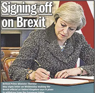  ??  ?? British Prime Minister Theresa May signs letter on Wednesday making the Brexit official as United Kingdom says it plans to withdraw from the European Union.