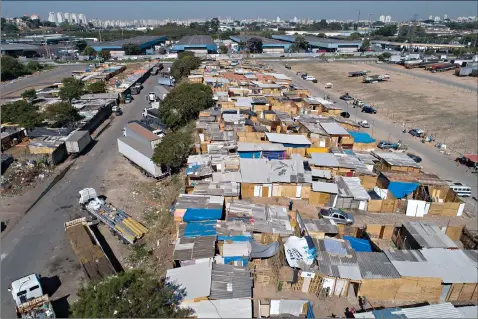  ?? (AP Photo/Andre Penner) ?? Shacks fill the Jardim Julieta squatter camp Thursday in Sao Paulo, Brazil. The coronaviru­s had just hit the city when this parking lot for trucks became a favela, with dozens of shacks. Since the first wave of residents in mid-March, hundreds of families joined, with most having been evicted during the pandemic.