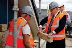  ?? (AFP/Getty) ?? Johnson visiting a constructi­on site in Warrington last week, as his government announced a major overhaul of planning policy