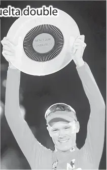  ?? AFP PHOTO ?? Team Sky’s British cyclist Chris Froome raises his trophy as he celebrates on the podium winning the 72nd edition of “La Vuelta” Tour of Spain cycling race, in Madrid, on Monday.