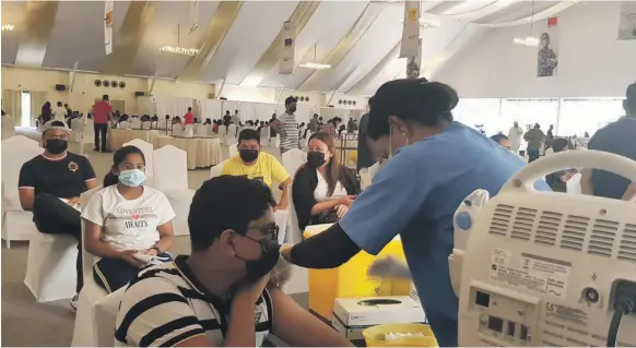  ?? Delhi Private School Dubai ?? Pupils at Delhi Private School Dubai receive their first dose of the Pfizer-BioNTech Covid-19 vaccine