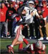  ?? ?? Xaverian quarterbac­k Henry Hasselbeck went for a ride after he was upended on this huge hit by CM’s defense.