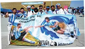  ?? ?? Flag day: Fans in Qatar hail the influence of Maradona and Messi