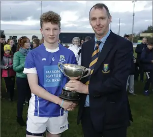  ??  ?? Éire Óg captain Thade Shanahan accepts the cup from Martin Fitzgerald.