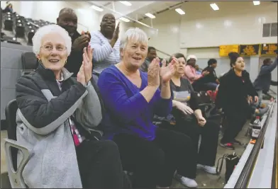  ?? Terrance Armstard/News-Times ?? Go Team: Strong High School fans Sharon McDowell, Jo Ann Dollar, seated below, Willie McHenry and Mashell McHenry, seated above, cheer for the Strong girls basketball team during the game against Bradley in Hampton during the first round of the 1A...