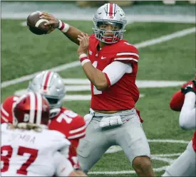  ?? ASSOCIATED PRESS FILE PHOTO ?? Ohio State quarterbac­k Justin Fields throws a pass against Indiana during the first half of a Nov. 21 game in Columbus, Ohio.