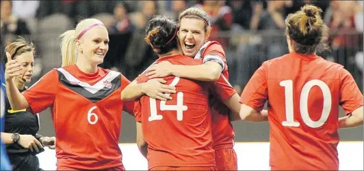  ?? IAN LINDSAY/ PNG ?? Canadian captain Christine Sinclair gives her teammate a hug after scoring her third of four goals against Haiti during Thursday’s opening match for both teams in the CONCACAF women’s Olympic qualifying tournament. Sinclair, of Burnaby, scored four...