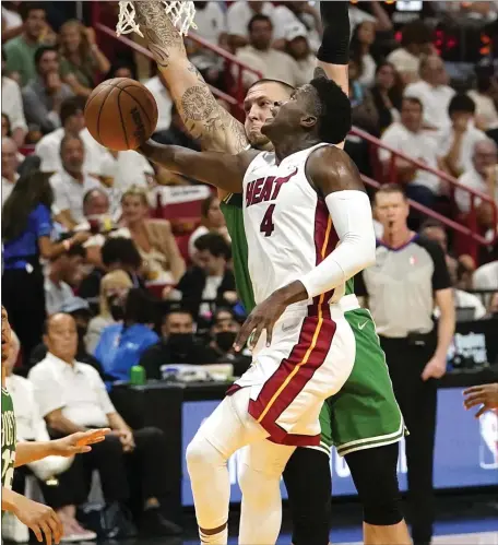  ?? AP ?? STRONG FINISH: Miami Heat guard Victor Oladipo drives to the basket as Celtics center Daniel Theis (27) defends during the first half of Game 1 of the Eastern Conference Finals on Tuesday in Miami.