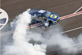  ?? BOB ANDRES/ASSOCIATED PRESS ?? NASCAR Cup Series driver Chase Elliott does a burnout after winning a race Sunday at Atlanta Motor Speedway in Hampton, Ga.