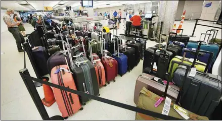  ??  ?? Baggage stacks up from delayed travellers in the baggage claim area in Denver Internatio­nal Airport, June 16, 2021, in Denver. The Biden administra­tion is planning to require that airlines refund fees on checked baggage if the bags get seriously delayed. The proposal would also require refunds for fees on extras like internet access if the airline fails to provide the service during the flight. (AP)