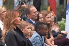  ?? OLIVIER DOULIERY/ AFP VIA GETTY IMAGES ?? First lady Melania Trump joins Jesse Barrett, husband of Amy Coney Barrett, and their children in the Rose Garden.