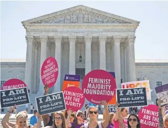  ?? ALEX BRANDON, AP ?? Demonstrat­ors on both sides of the abortion issue rally in front of the Supreme Court last year. An undocument­ed teen has won a court battle to have an abortion.