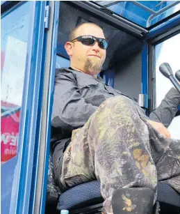  ?? ?? Callum Sayles, of Levin Crane Hire, takes a rest from the controls after expertly transporti­ng Santa Claus to the main street of the town, signalling the start of the festive season.