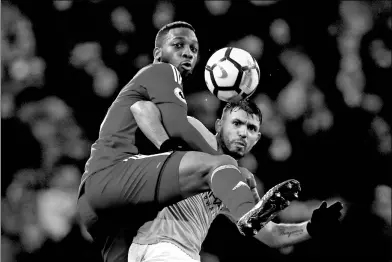  ?? JASON CAIRNDUFF / ACTION IMAGES VIA REUTERS ?? Manchester City’s Sergio Aguero and Watford's Molla Wague tussle during City’s 3-1 English Premier League victory at Etihad Stadium in Manchester on Tuesday.