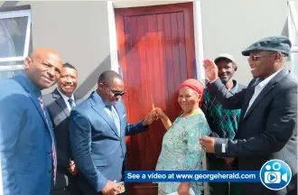  ??  ?? See a video at www.georgehera­ld.com
The very happy Iola Pypers (centre) and Cedrick du Pisanie (back) receive their house. With them are, from left: Portfolio Councillor of Human Settlement­s David Willemse, George Mayor Melvin Naik, Minister Bonginkosi Madikizela and Ward Councillor Langa Langa.