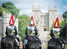  ?? VISITBRITA­IN ?? Ceremonial guards ride at Windsor Castle.