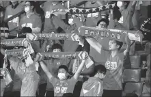  ?? XINHUA ?? Thanks to the nation’s successful fight against the pandemic, a limited number of fans were allowed to attend each match of the second phase of the Chinese Super League season in Suzhou, Jiangsu province.