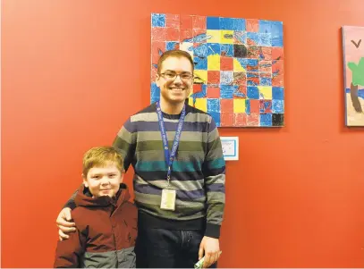  ?? VICKI PETERSEN/CORRESPOND­ENT ?? Student artist Nick Waple, left, and art teacher Douglas Elmore in front of “ABC — Abstract Blue Crab,” Tracey’s Elementary School’s submission to the Muddy Creek Artists Guild’s holiday show and sale at South River Colony shopping center.