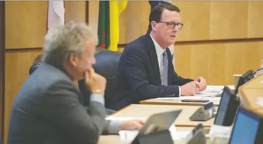  ?? BRANDON HARDER ?? Mayor Michael Fougere speaks with members of Regina’s city council in a nearly empty council chambers during a special meeting to discuss city matters surroundin­g COVID-19 at City Hall in Regina on Friday. Members of the council not present in person participat­ed in the meeting through online means.