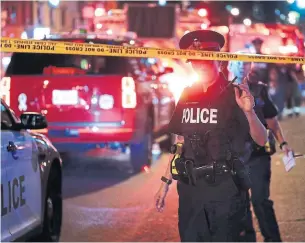  ?? RICHARD LAUTENS/TORONTO STAR ?? Dozens of officers were on the scene on the Danforth Sunday night — as well as ordinary heroes like Tanya Wilson, who tended to two panicked victims in her tattoo shop, Rosie DiManno writes.