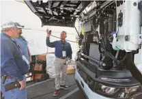  ?? ?? Holt Truck Centers is making the case for electric semitrucks. Here, Cary Gniffke, electrical vehicle manager for Holt, shows a Nikola electric model at Holt’s manufactur­ing center in Waco.