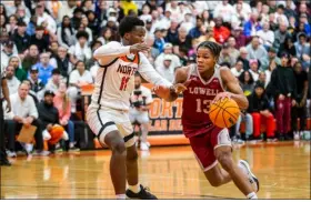  ?? JAMES THOMAS PHOTO ?? Lowell’s Tzar Powell-aparicio tries to drive past North’s Omari Scott during Friday’s clash. North rolled, 98-52.