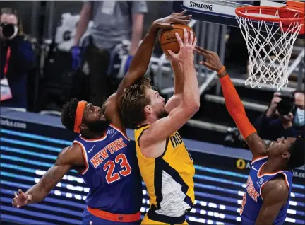  ?? MICHAEL CONROY - STAFF, AP ?? New York Knicks center Mitchell Robinson (23) blocks the shot over Indiana Pacers forward Domantas Sabonis (11) during the second half of an NBA basketball game in Indianapol­is, Wednesday, Dec. 23, 2020.