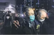  ?? AFP ?? Pro-democracy activist Benny Tai, second right, is escorted to his car after leaving Ma On Shan Police station last Thursday.