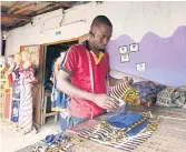  ??  ?? STRANDED: Dressmaker Ibrahim Doumbia, 31 years old, works in his workshop in Daloa.