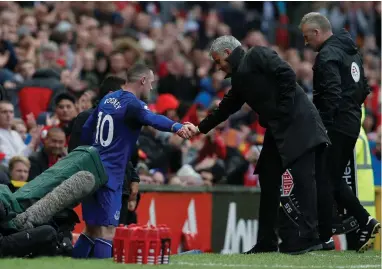  ??  ?? WELCOME BACK, WAYNE: Jose Mourinho greets ex Manchester United star Wayne Rooney, now with Everton at Old Trafford on Sunday.