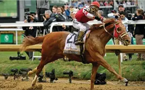  ?? (Robert Goddin/USA Today Sports) ?? SONNY LEON aboard Rich Strike celebrates as he crosses the finish line to win Saturday’s 148th running of the Kentucky Derby at Churchill Downs in Louisville.