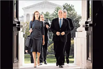  ?? ERIN SCHAFF/THE NEW YORK TIMES ?? With the Supreme Court in the background, Amy Coney Barrett and Vice President Mike Pence enter the Capitol on Tuesday.