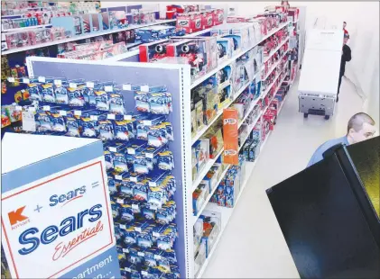  ?? AP PHOTO ?? In this 2005 file photo Kenmore refrigerat­ors are wheeled into the existing K-mart in Nashua, N.H., to become a “Sears Essentials” store.