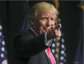  ?? JAKE DANNA STEVENS — THE TIMES & TRIBUNE VIA AP ?? Republican presidenti­al candidate Donald Trump points to the crowd after a campaign rally at Lackawanna College Wednesday in Scranton, Pa. speaking during