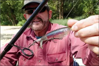  ?? NWA Democrat-Gazette/FLIP PUTTHOFF ?? Tonkinson shows a Whopper Plopper top-water lure that worked best for catching smallmouth bass from the Elk River. Fishing slows in fall as the river water cools.