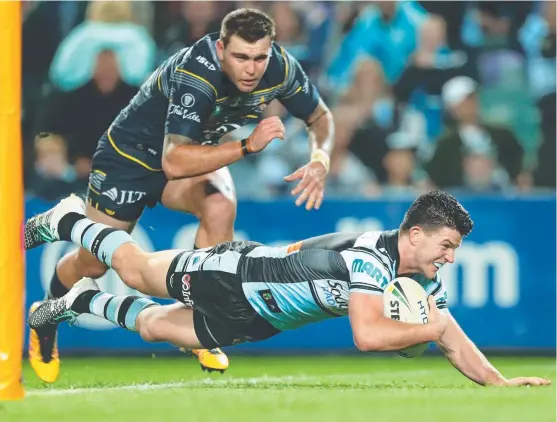  ?? Picture: AAP ?? Chad Townsend scores a try as Cronulla forced their way past the Cowboys last night at Allianz Stadium and into the NRL grand final.