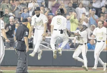  ?? REBECCA S. GRATZ — THE ASSOCIATED PRESS ?? Vanderbilt’s Isaiah Thomas (8), Carter Young (9), Javier Vaz (2) and Parker Noland (25) celebrate their 6-5 win against Stanford in the CWS on Wednesday in Omaha, Neb.